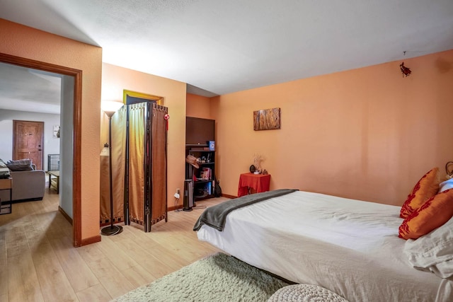 bedroom with light wood-type flooring