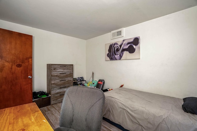 bedroom with hardwood / wood-style flooring