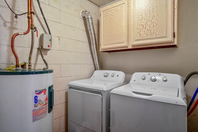 washroom featuring cabinets, electric water heater, and washing machine and clothes dryer