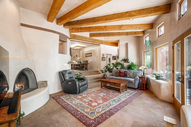 living room featuring a large fireplace and beam ceiling