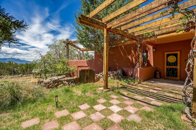 view of yard featuring a pergola and a mountain view