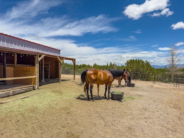 view of stable featuring a rural view