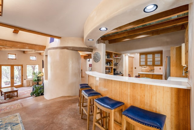 bar featuring stainless steel fridge, french doors, and beamed ceiling