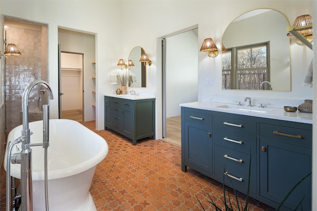 bathroom with vanity and a bath