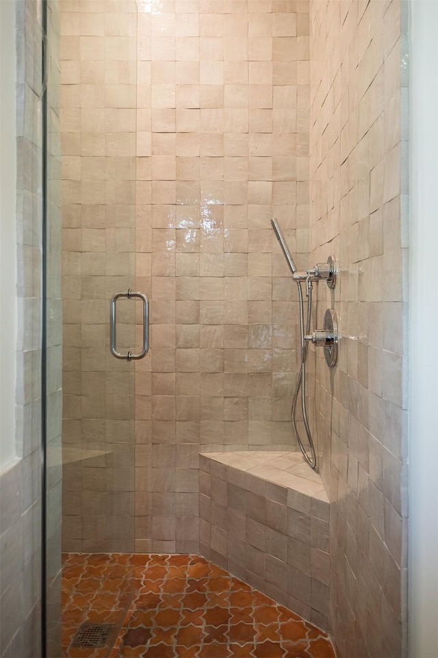 bathroom featuring a shower with door