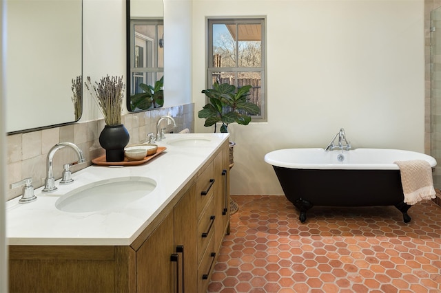 bathroom with tile patterned floors, vanity, backsplash, and a bath