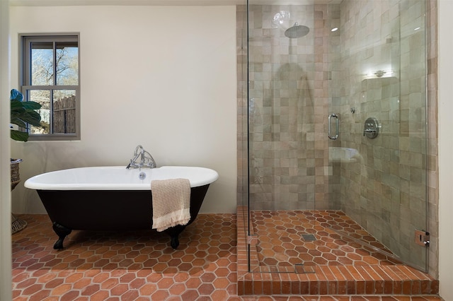 bathroom featuring tile patterned flooring and shower with separate bathtub