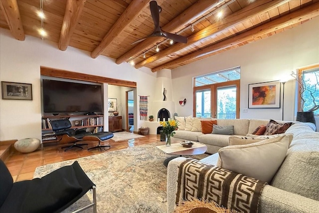 living room with french doors, tile patterned flooring, track lighting, wood ceiling, and beam ceiling