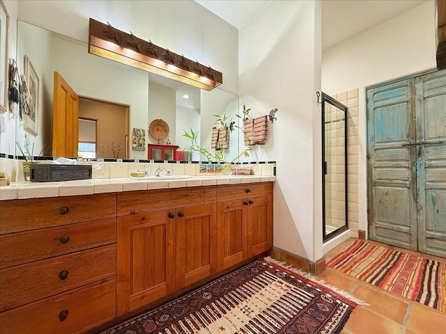 bathroom with vanity, tile patterned floors, and a shower with shower door