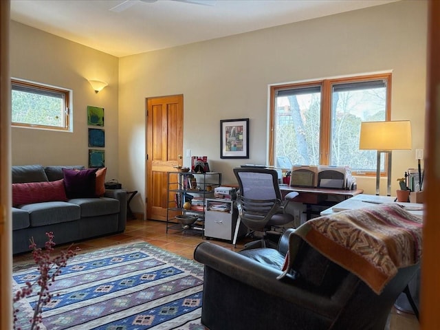 living room with tile patterned floors and a healthy amount of sunlight