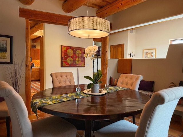 dining area with beam ceiling