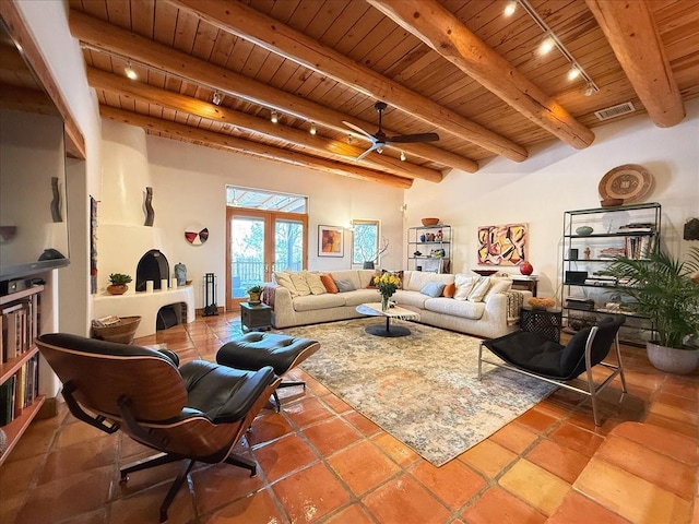 living room featuring track lighting, beam ceiling, ceiling fan, and wood ceiling