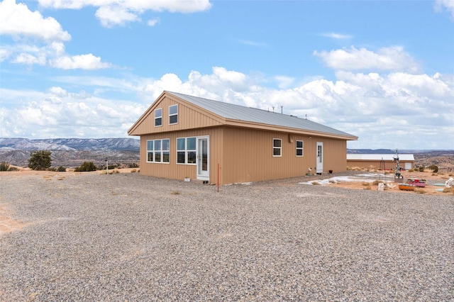 rear view of property featuring a mountain view