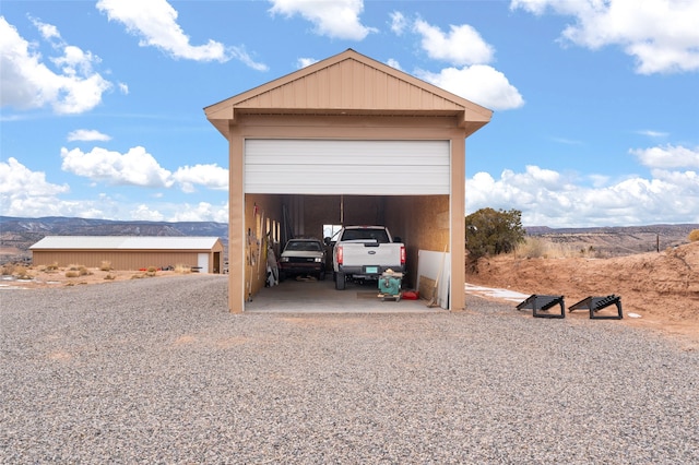 garage featuring a carport and a mountain view