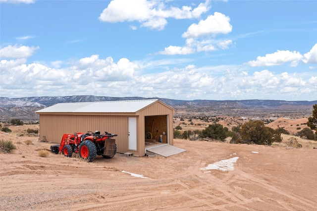 view of outbuilding featuring a mountain view and a garage