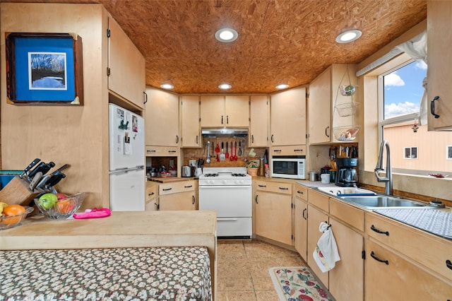 kitchen featuring white appliances, tasteful backsplash, and sink