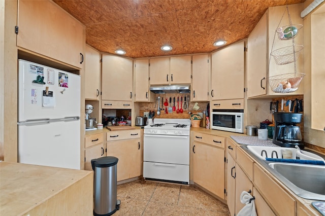 kitchen featuring white appliances and sink