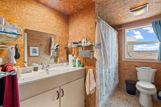 bathroom featuring tile patterned flooring, vanity, a shower with shower curtain, and toilet