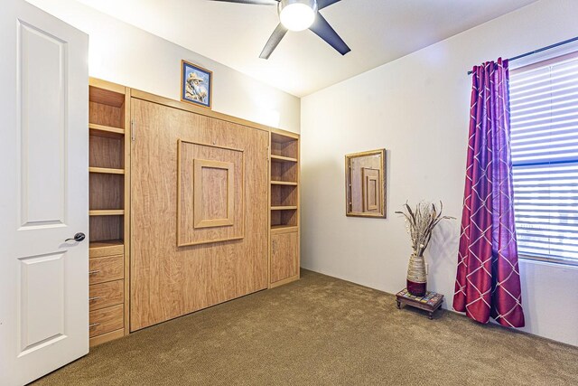 unfurnished bedroom with carpet floors and ceiling fan