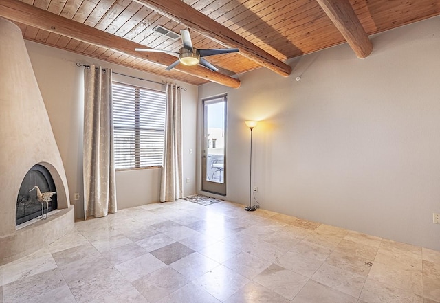 unfurnished living room featuring beam ceiling, ceiling fan, a large fireplace, and wood ceiling