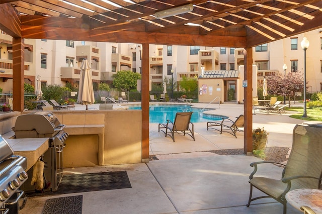 view of pool featuring a pergola, area for grilling, a patio, and grilling area