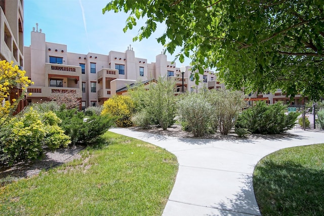 view of home's community featuring a lawn