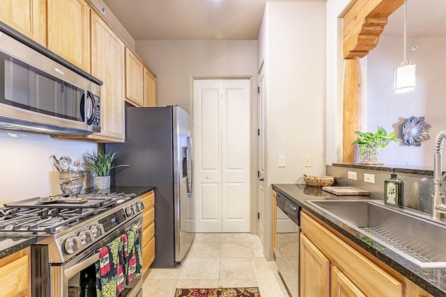 kitchen featuring light brown cabinets, sink, decorative light fixtures, light tile patterned floors, and appliances with stainless steel finishes