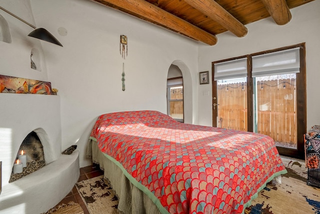 tiled bedroom with beamed ceiling and wooden ceiling