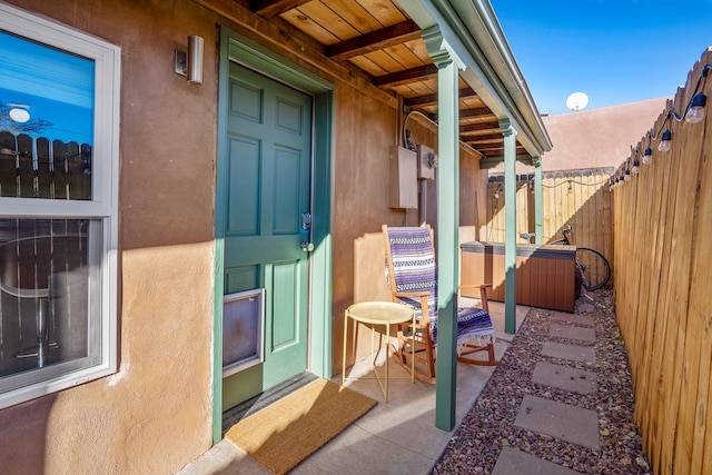 view of exterior entry with a patio