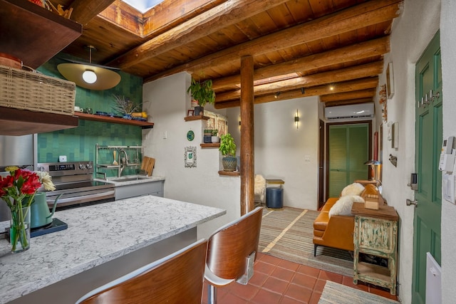 kitchen featuring stainless steel range with electric stovetop, sink, beamed ceiling, and a wall mounted AC