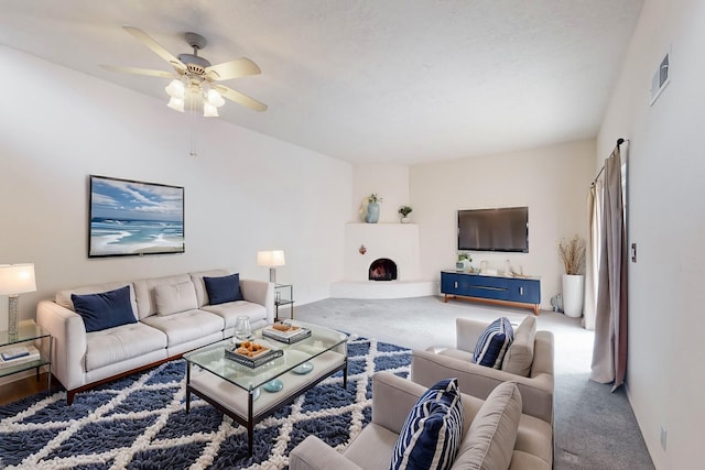 carpeted living room featuring ceiling fan