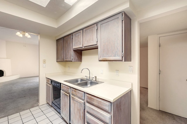 kitchen featuring dishwasher, ceiling fan, light colored carpet, and sink