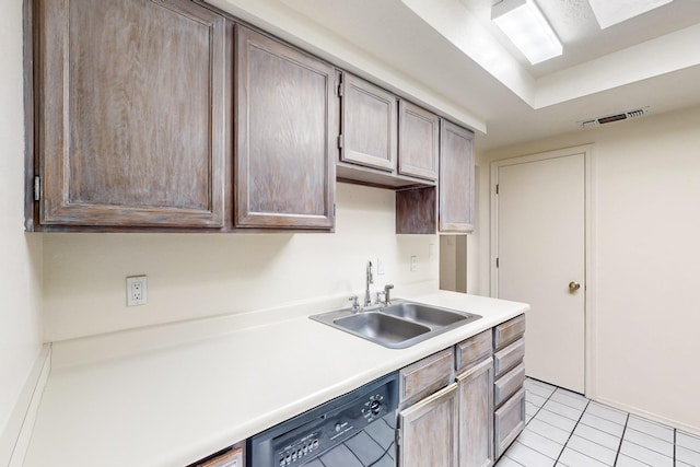 kitchen with dishwasher, light tile patterned floors, and sink