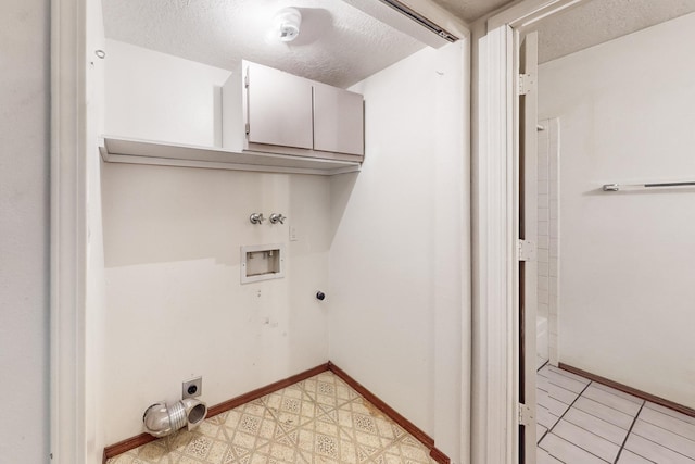 laundry area with hookup for an electric dryer, cabinets, a textured ceiling, and hookup for a washing machine