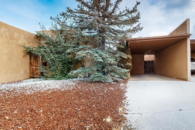 view of property exterior featuring a carport