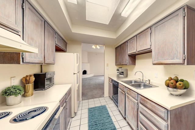 kitchen featuring an inviting chandelier, sink, light tile patterned floors, black dishwasher, and a tray ceiling