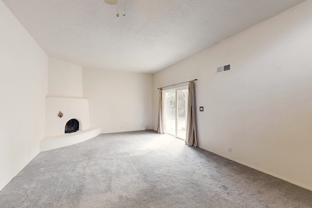 unfurnished living room featuring ceiling fan and carpet floors