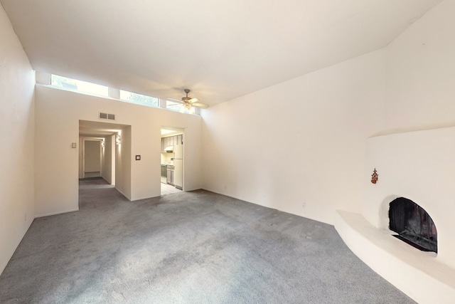 unfurnished living room with carpet flooring and ceiling fan