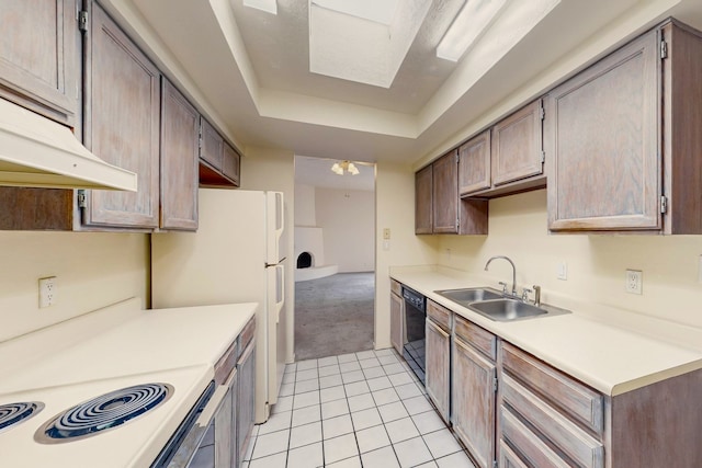 kitchen featuring a raised ceiling, sink, light tile patterned floors, black dishwasher, and white fridge