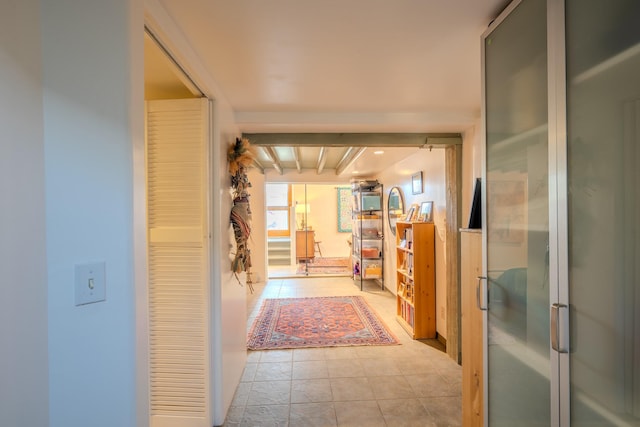 hall featuring light tile patterned floors