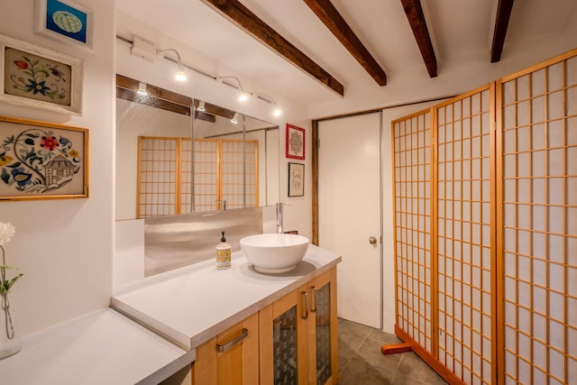 bathroom with vanity and beamed ceiling