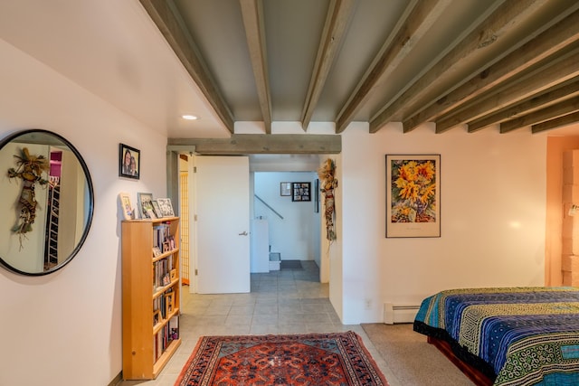 bedroom with light tile patterned flooring and a baseboard heating unit