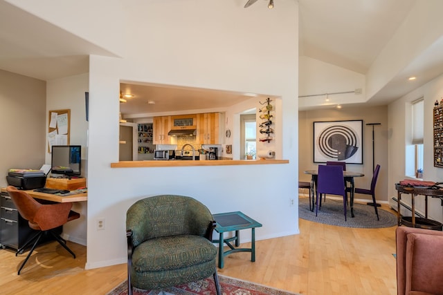 sitting room featuring lofted ceiling and light hardwood / wood-style flooring