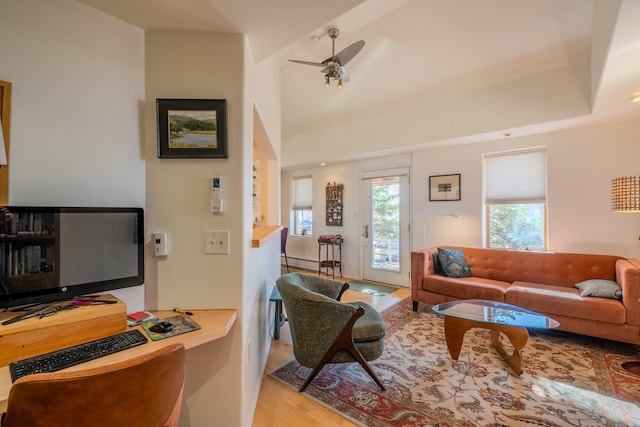 living room with ceiling fan and light hardwood / wood-style flooring