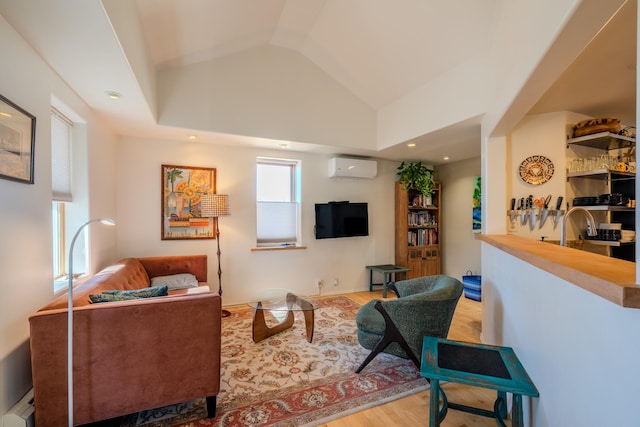 living room featuring vaulted ceiling, light hardwood / wood-style flooring, a baseboard heating unit, a wall mounted air conditioner, and sink