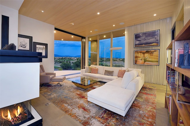 living room featuring a mountain view and wooden ceiling