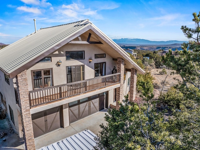 view of front of house featuring a balcony, a garage, and a mountain view