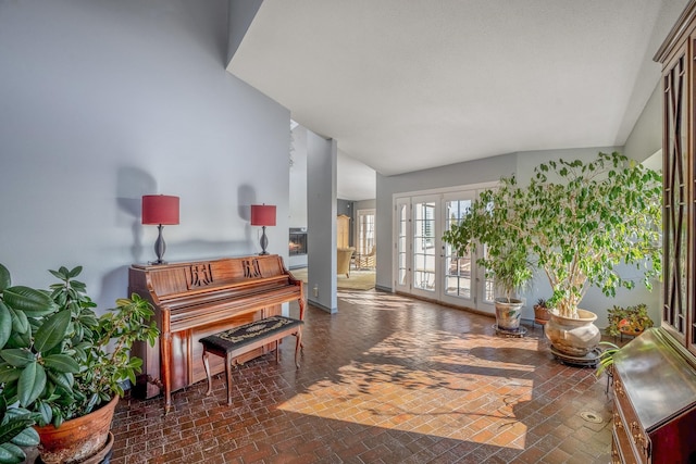 miscellaneous room with french doors and vaulted ceiling