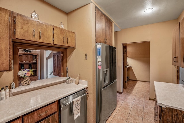 kitchen with stainless steel appliances and light tile patterned floors