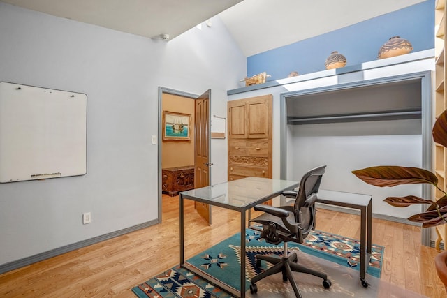 office featuring vaulted ceiling and hardwood / wood-style flooring